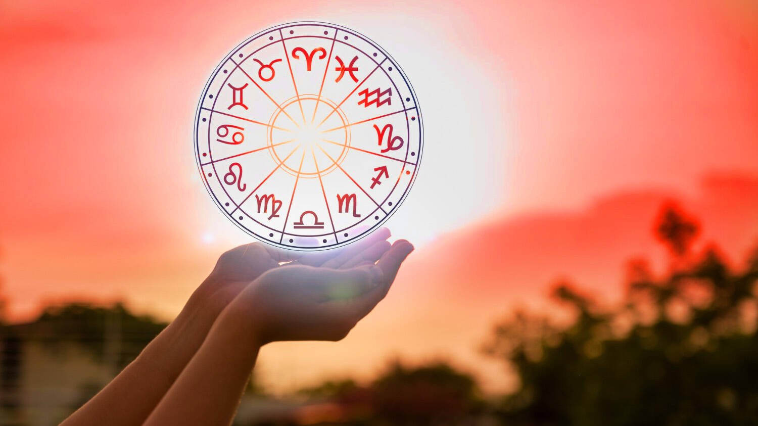 A zodiac wheel holding on a hand