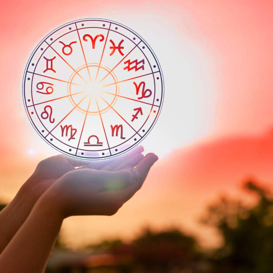 A zodiac wheel holding on a hand